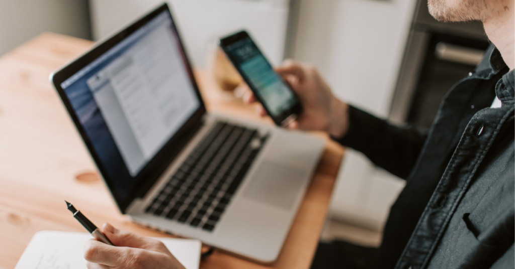 Office workspace with a laptop and phonebook highlighting uk phonebook alternatives and online directories