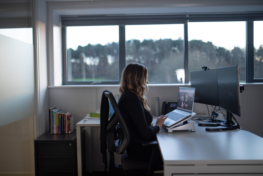 Colleague using a laptop in a modern office, supported by telecoms Donegal solutions for remote and flexible working in the North West