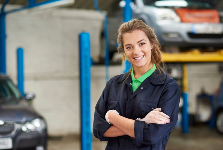 female mechanic working in garage using phone systems for mechanics
